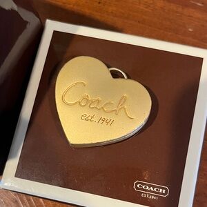 COACH locket. NIB, matte gold